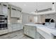 Gourmet kitchen with white cabinets, large island, and farmhouse sink at 2197 Nita Ter, North Port, FL 34286