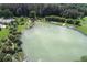 Aerial view of a spring-fed lake surrounded by trees and recreational areas at 2197 Nita Ter, North Port, FL 34286