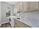 Bright laundry room with washer, dryer, and ample cabinetry at 2197 Nita Ter, North Port, FL 34286