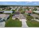 Aerial view of a house in a residential neighborhood with a large yard at 5864 Tyler Rd, Venice, FL 34293