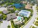 Aerial view of community pool, tennis courts, and clubhouse at 1160 Yosemite Dr, Englewood, FL 34223