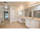 Bathroom with double vanity and a view of the bedroom at 1886 Cardwell Ct., North Port, FL 34288