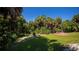 Landscaped backyard with tropical plants and grassy area at 1886 Cardwell Ct., North Port, FL 34288