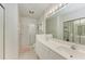 Double vanity bathroom with a shower and updated fixtures at 872 Saranac Lake Dr # 202, Venice, FL 34292