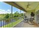Spacious screened balcony overlooking a peaceful canal; perfect for outdoor relaxation at 872 Saranac Lake Dr # 202, Venice, FL 34292