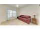 Living room with leather sofa and light flooring at 872 Saranac Lake Dr # 202, Venice, FL 34292