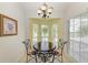 Charming breakfast nook with a round table and three chairs at 872 Saranac Lake Dr # 202, Venice, FL 34292