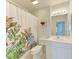 Bathroom with floral shower curtain and white vanity at 872 Saranac Lake Dr # 202, Venice, FL 34292