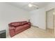 Bedroom with leather sofa and white closet doors at 872 Saranac Lake Dr # 202, Venice, FL 34292