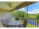 Screened balcony with a table and chairs overlooking a tranquil waterway at 872 Saranac Lake Dr # 202, Venice, FL 34292