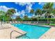 Community pool with lounge chairs and patio area at 872 Saranac Lake Dr # 202, Venice, FL 34292