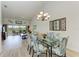 Dining area with glass table and view to living room at 872 Saranac Lake Dr # 202, Venice, FL 34292