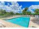 Community pool with lounge chairs and patio area at 872 Saranac Lake Dr # 202, Venice, FL 34292