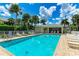 Community pool with lounge chairs and patio area at 872 Saranac Lake Dr # 202, Venice, FL 34292