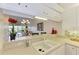 Kitchen features a breakfast bar overlooking the living room at 872 Saranac Lake Dr # 202, Venice, FL 34292