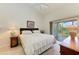 Spacious bedroom with king-size bed and access to private balcony at 872 Saranac Lake Dr # 202, Venice, FL 34292