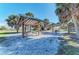Relaxing picnic area with covered tables, grills, and palm trees at 872 Saranac Lake Dr # 202, Venice, FL 34292