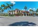 Exterior view of a commercial building with palm trees and parking at 872 Saranac Lake Dr # 202, Venice, FL 34292
