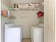 Laundry room with washer, dryer, and shelving at 872 Saranac Lake Dr # 202, Venice, FL 34292