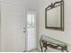 Bright entryway with white door and decorative mirror at 872 Saranac Lake Dr # 202, Venice, FL 34292