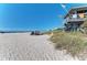Beach with lifeguard stand, golf cart, and people enjoying the sand at 872 Saranac Lake Dr # 202, Venice, FL 34292