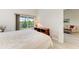 Bright bedroom with king-size bed and view of the backyard at 872 Saranac Lake Dr # 202, Venice, FL 34292