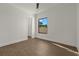 Bright bedroom with wood-look flooring and large window at 15060 Aquarius Cir, Port Charlotte, FL 33981