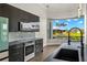 Modern kitchen with stainless steel appliances and a large window overlooking the water at 15060 Aquarius Cir, Port Charlotte, FL 33981