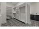 Large walk-in closet with shelving, drawers, and stylish flooring at 15060 Aquarius Cir, Port Charlotte, FL 33981