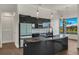 Modern kitchen features a large island, water views, and high-end finishes at 15060 Aquarius Cir, Port Charlotte, FL 33981