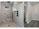 Spa-like shower with marble walls, built-in seat, and rainfall shower head at 15060 Aquarius Cir, Port Charlotte, FL 33981