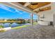 Covered patio with outdoor kitchen, water views, and ceiling fans at 15060 Aquarius Cir, Port Charlotte, FL 33981