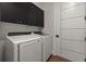 Laundry room with modern washer and dryer, and ample storage at 15060 Aquarius Cir, Port Charlotte, FL 33981