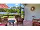 Relaxing screened patio with wicker furniture overlooking backyard at 248 Ibiza Loop, Venice, FL 34292