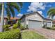 Exterior of a two-car garage villa with landscaping at 18837 Lanuvio St, Venice, FL 34293