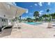 Relaxing pool area with patio furniture and covered seating at 262 Sun Air Cir, Osprey, FL 34229