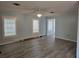 Living room with light blue walls, new flooring, and plantation shutters at 2961 Valencia Rd, Venice, FL 34293