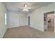 Bright bedroom with ceiling fan, and doors to laundry and bathroom at 5847 Wilson Rd, Venice, FL 34293