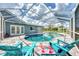 Relaxing pool area with covered patio and lounge chairs at 5076 Kingsley Rd, North Port, FL 34287