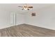 Bedroom with wood-look floors and access to bathroom and closet at 5076 Kingsley Rd, North Port, FL 34287