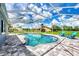 Inviting screened pool area with large patio and lawn at 5076 Kingsley Rd, North Port, FL 34287