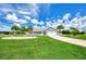 Single-Gathering home with a manicured lawn and palm trees at 5076 Kingsley Rd, North Port, FL 34287