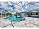 Inviting screened pool area with large patio and lawn at 5076 Kingsley Rd, North Port, FL 34287