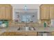Well-equipped kitchen with granite countertops and stainless steel sink at 5076 Kingsley Rd, North Port, FL 34287