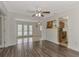Open living space with wood floors and access to kitchen and patio at 5076 Kingsley Rd, North Port, FL 34287