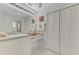 Bathroom with white vanity, tile floor, and linen closet at 5076 Kingsley Rd, North Port, FL 34287