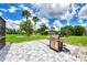 Outdoor patio with built-in grill and spacious lawn at 5076 Kingsley Rd, North Port, FL 34287
