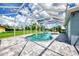 Inviting screened pool area with large patio and lawn at 5076 Kingsley Rd, North Port, FL 34287
