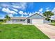 Single story home with light blue exterior, tile roof and landscaping at 5076 Kingsley Rd, North Port, FL 34287