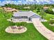 Single-story home with a tile roof, large yard, and palm trees at 5076 Kingsley Rd, North Port, FL 34287